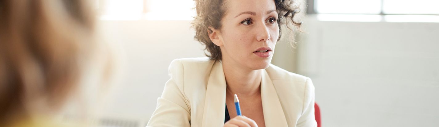 A healthcare IT professional at work in a meeting